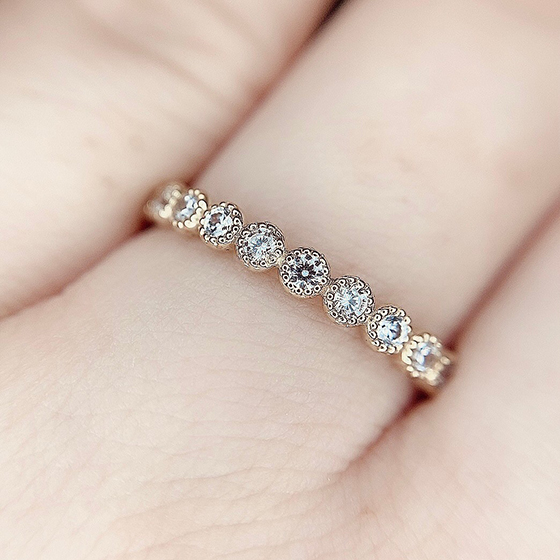 ダイヤモンドの縁にミル打ち加工が施された結婚指輪。