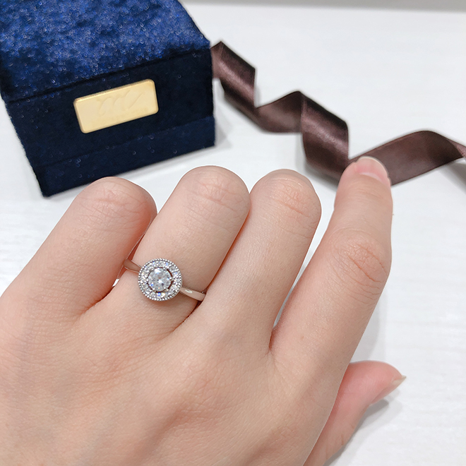 取り囲むメレダイヤモンドが中央のダイヤモンドをより大きく見せるデザインです。存在感のある婚約指輪をお探しの方へ。
