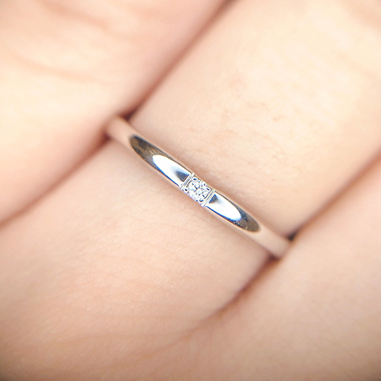 シンプルストレートな結婚指輪。大きめのダイヤモンドがセットされ存在感があります。