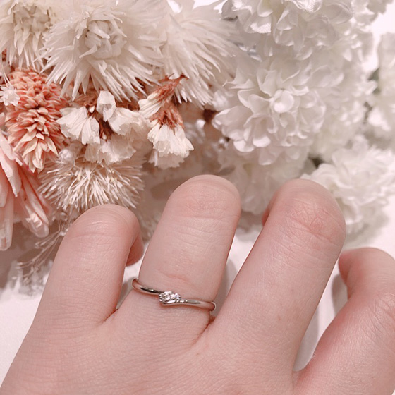 ダイヤモンドを抱え込んだような可愛らしいデザインの結婚指輪。細身タイプなのでお指を綺麗に魅せてくれます。