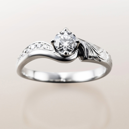 手彫りがメインのダイヤモンドを引き立てるためのデザインのMAKANAの婚約指輪は、指輪全体でハワイの自然を表現しています。